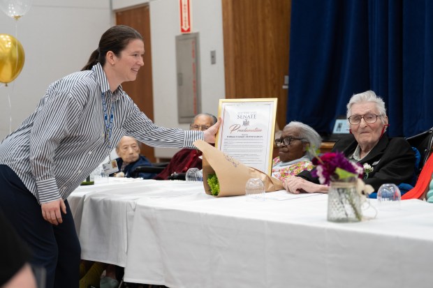 Antonia Strk presents William Conrad, 100, with a New York State senate proclamation during a birthday celebration for people 100 years old and older at the New Jewish Home in Harlem on Tuesday, Sept. 30, 2025, in Manhattan, New York. (Barry Williams/ New York Daily News)