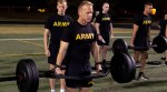 Army recruit performing trap bar deadlifts on a field